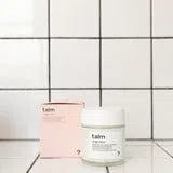 Baume hydratant visage et corps contre vergetures pour grossesse et post partum de Talm à côté de leur boîte