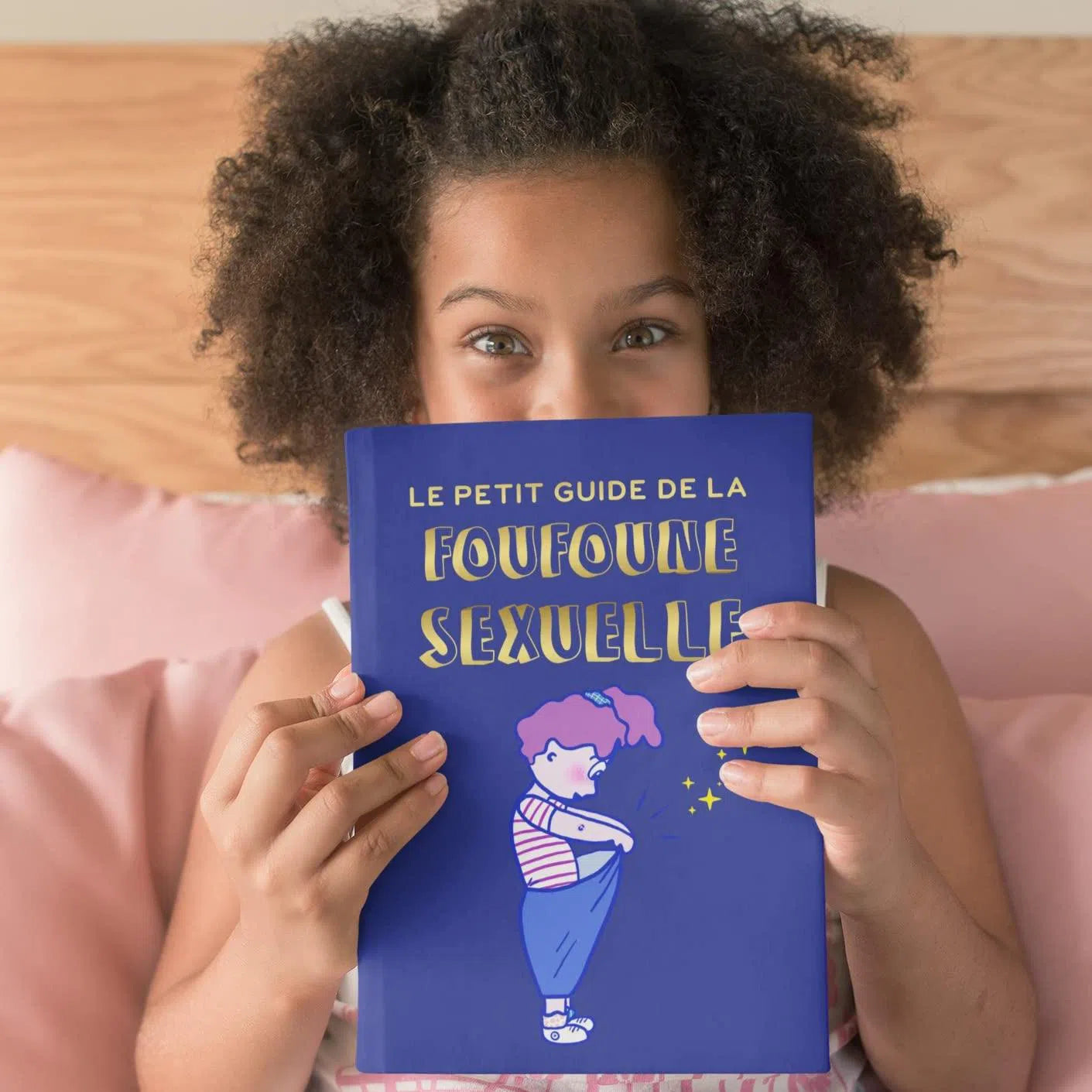 Petite fille sui tient le petit guide de la foufoune sexuelle tome 1 de Julia Pietri qui est unlivre d'éducation sexuelle pour les enfants