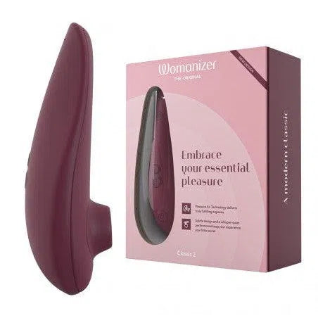 Sextoy clitoridien à air pulsée Classic 2 violet de Womanizer à côté de sa boîte